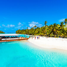 Boat on a sandy beach in Aitutaki island, Cook Islands, South Pacific. 