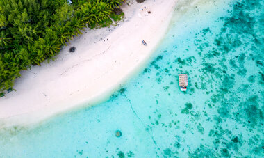Boat on a sandy beach in Aitutaki island, Cook Islands, South Pacific. 